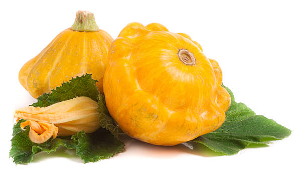 istock two yellow pattypan squash with leaf and flower isolated on 598176962
