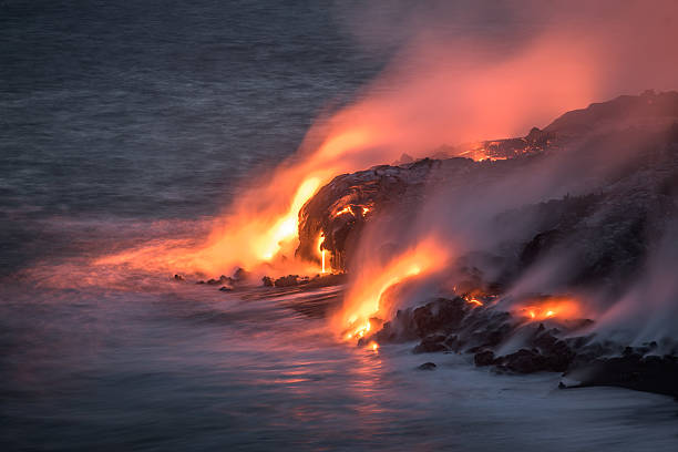 Lava stream of Kilauea volcano running into the Pacific Ocean stock photo