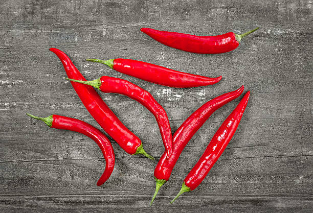 istock Red chili peppers on wooden background 598179192