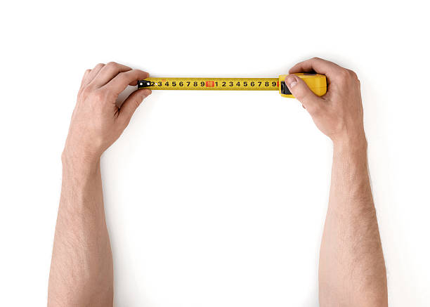 istock Close-up view of man's hands measuring something with 598179244