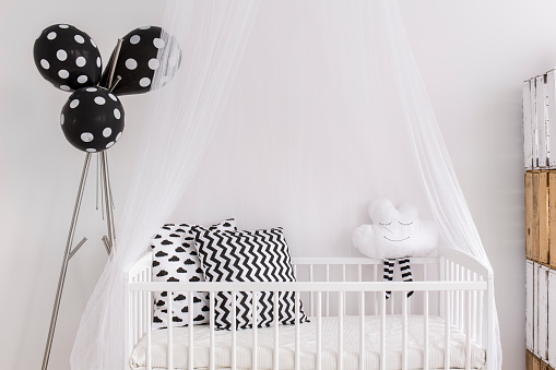 Shot of a crib in a modern black and white baby room