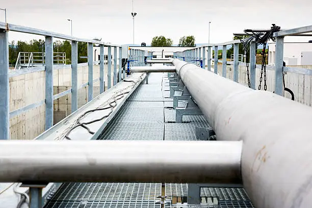Wastewater treatment plant pipes. Water pumping station. Wastewater treatment is a process used to convert dirty wastewater into an effluent that can be either returned to the water cycle with minimal environmental issues or reused.