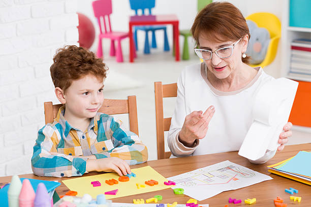 istock Speech therapist and little patient 598214344