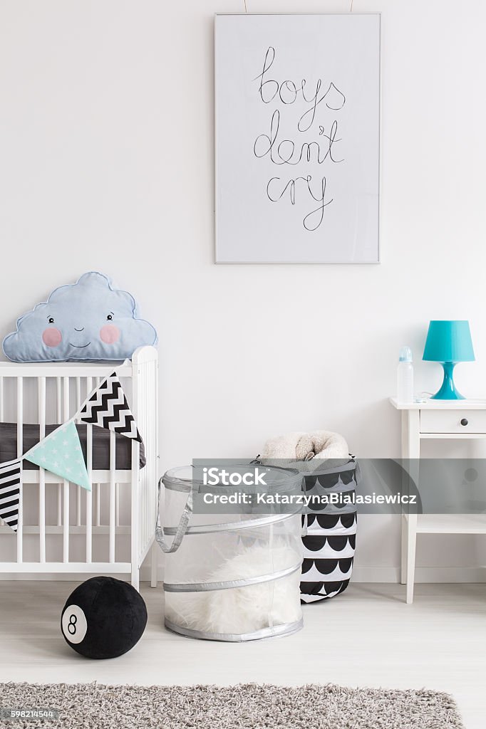 Postcard from a newborn's friendly world Fragment of a cot, containers and a nightstand in a baby room Crib Stock Photo
