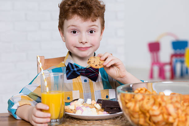 istock Little glutton and plate full of sweets 598214714