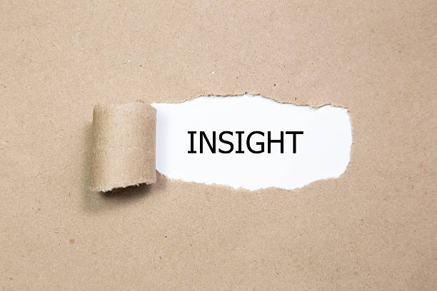 istock The word Insight appearing behind torn brown paper. 598214794