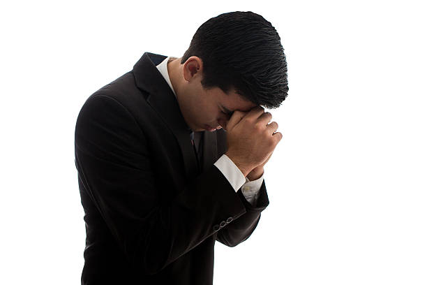 istock Young businessman praying with hands together 598215028