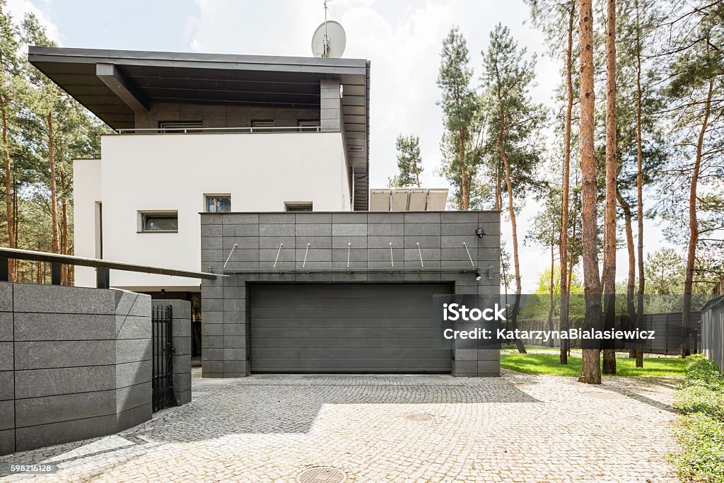 Special place for the car Shot of a big modern house and its garage Garage Stock Photo