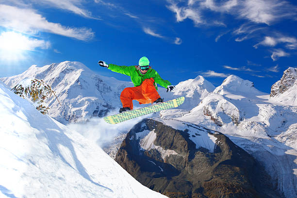 istock Snowboarder jumping against blue sky 598216312