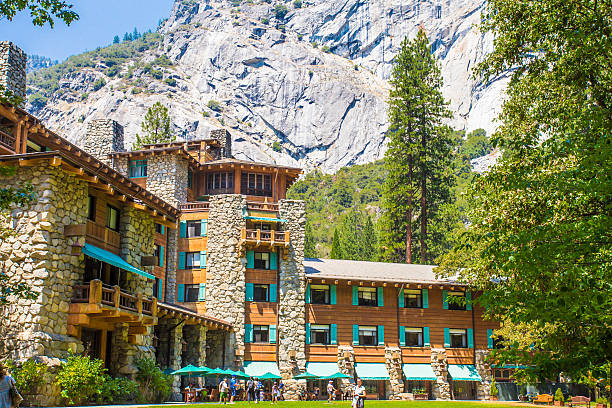 Yosemite National Park, California, USA  - August 3, 2016:  Exterior view with people visible of the historic Majestic Yosemite Hotel, formerly known as Ahwahnee Hotel in Yosemite Valley.  This well visited hotel was opened in 1927. 