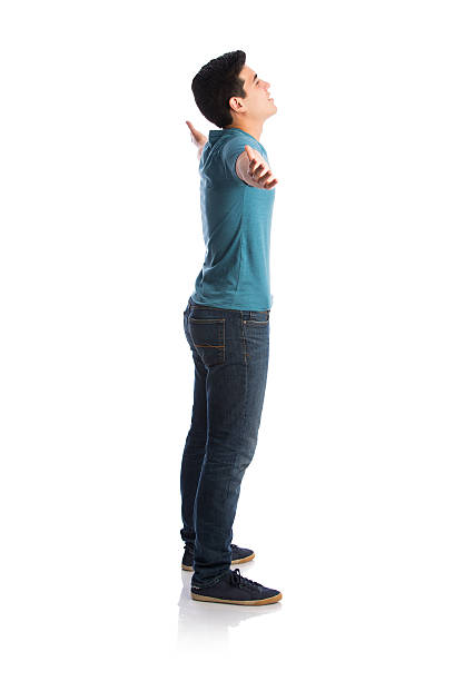 Rear view full length portrait of active young man pulling something imaginary or holding strong with hands lifted up isolated over transparent background