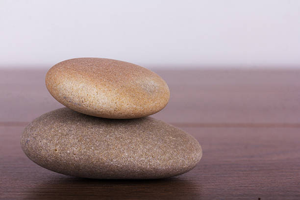 istock Stacked pebbles on a rustic wooden background 598217682