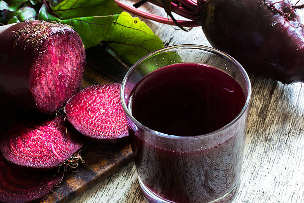 fresh beet juice in a glass. healthy detox drink fresh beet juice in a glass with sliced vegetables on wooden background. healthy detox drink. close up beta vulgaris stock pictures, royalty-free photos & images