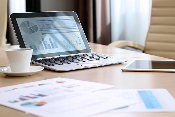 istock working place with laptop, digital tablet; graphs at the office 598218030