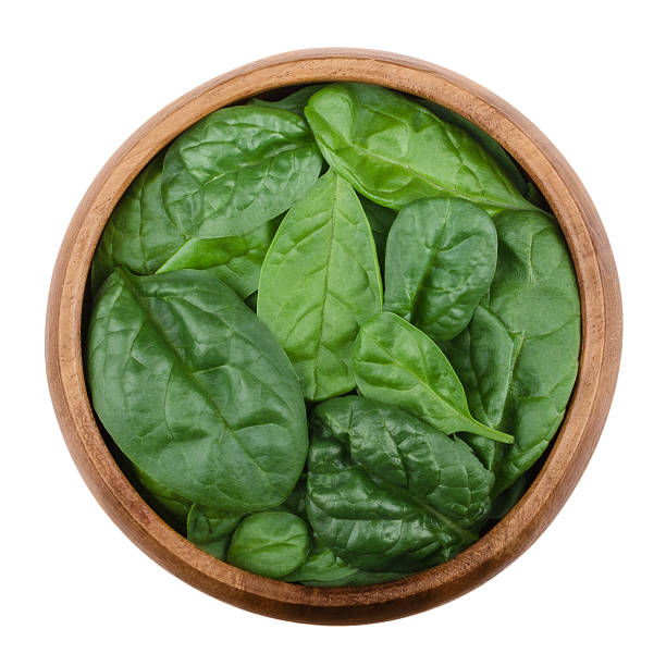 istock Fresh spinach leaves in a bowl over white 598218108