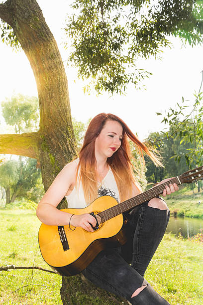 istock woman with guitar 598221020