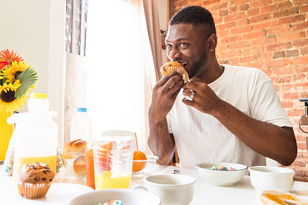 istock man doing the breakfast at home with muffin 598221712