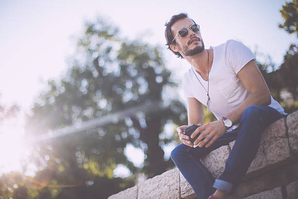 istock Hipster sitting on rampart 598222220
