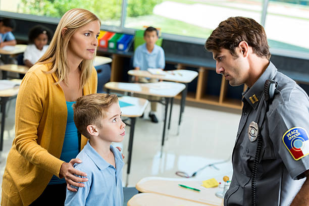 istock Private school student listens to security officer 598222530