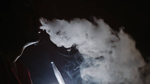 istock Man smokes in the dark 598222804