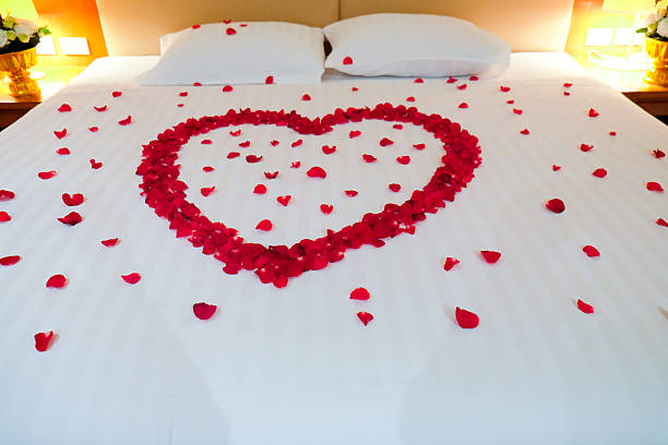 istock Wedding bed topped with rose petals 598227572