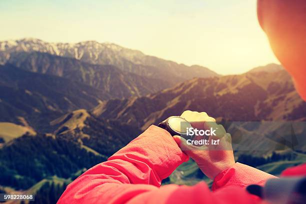 Young Woman Hiker Checking The Altimeter On Sports Watch Stock Photo - Download Image Now