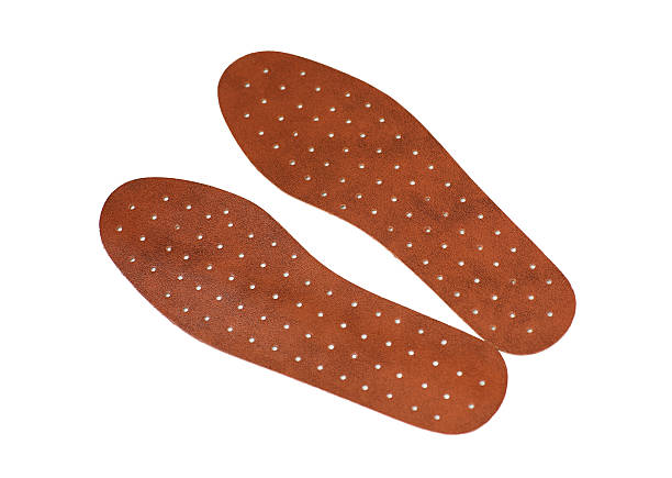 istock Pair of brown leather insoles on a white background 598229158