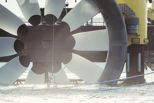 A newly constructed tidal turbine is made ready for deployment on the ocean floor in the Bay of Fundy.