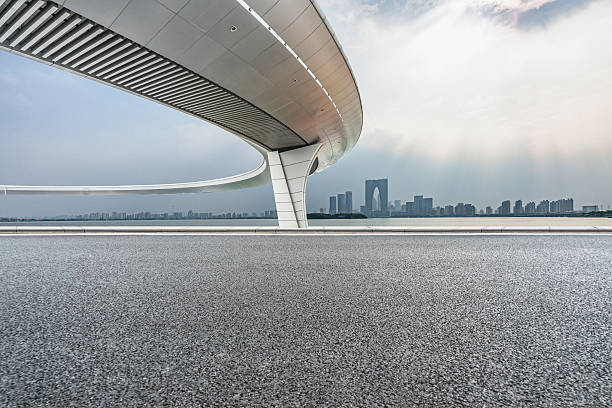 clean asphalt road with city skyline background