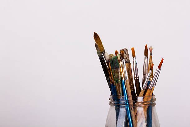 istock Paint brushes in a pot against a white background 598231994