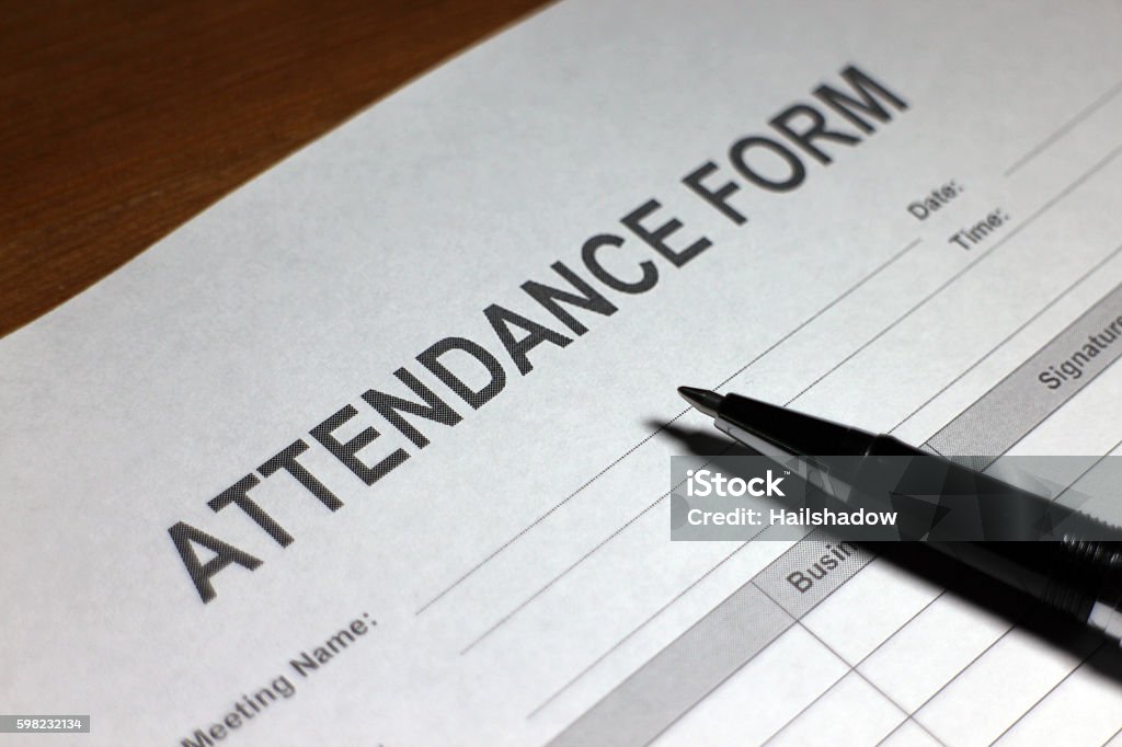 Attendance Form Someone filling out Attendance Form. Attending Stock Photo