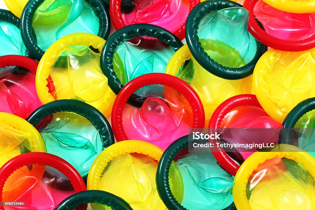 Colored Condoms Close Up A close up image of a multitude of colored condoms Condom Stock Photo