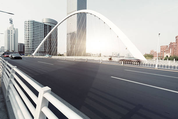 urban traffic on bridge with cityscape in background