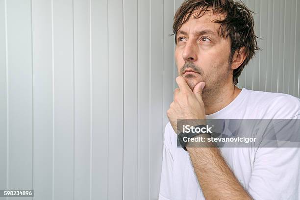 Man With Hand On Chin Thinking Deep Thoughts Stock Photo - Download Image Now - Adult, Adults Only, Asking