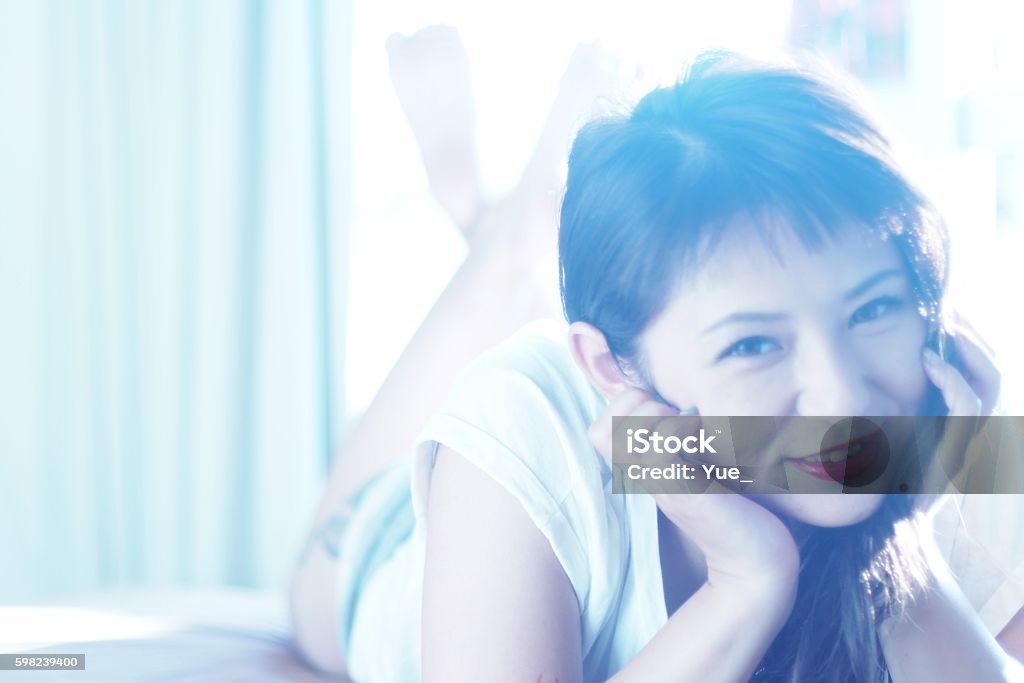 Young woman lying on front a young woman with a belly Adult Stock Photo