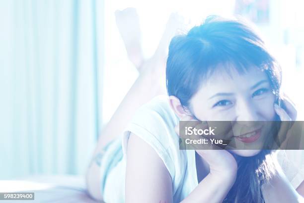 Young Woman Lying On Front Stock Photo - Download Image Now - Adult, Adults Only, Asian and Indian Ethnicities