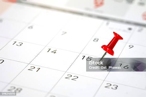 Embroidered Red Pins On A Calendar Stock Photo - Download Image Now - Calendar, Deadline, Event