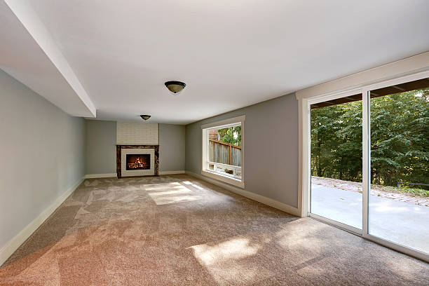 istock Empty long living room interior with carpet floor and fireplace. 598240864