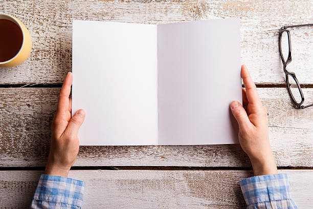 istock Unrecognizable woman holding empty greeting card. Studio shot. 598243872
