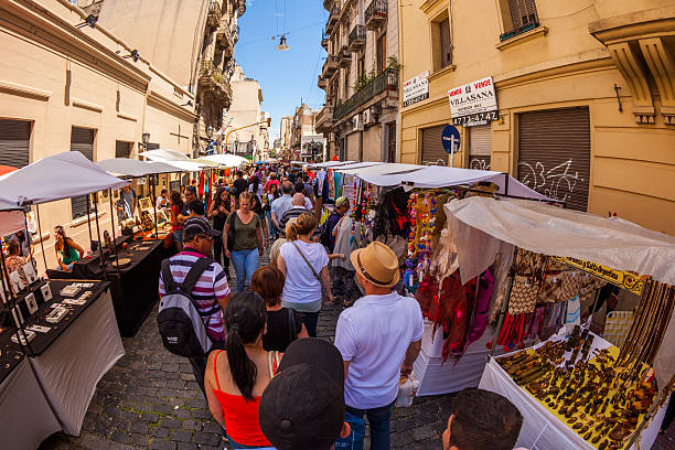 Buenos Aires, Argentina - January 21, 2013: Street filled with crowds of people looking through various shops in the San Telmo market in Buenos Aires, Argentina.