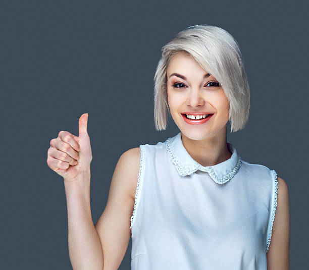 woman with thumb up stock photo