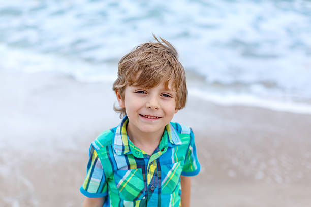 istock little kid boy on the beach of ocean 598246604