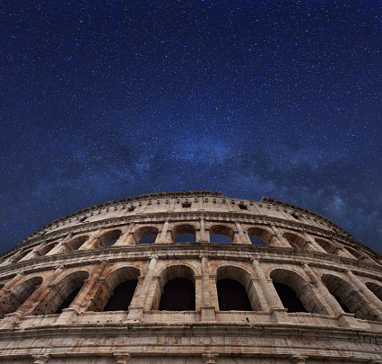Famous Rome coliseum and milky way in the midnight sky. Italy.