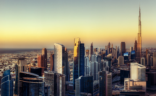 Colorful aerial skyline at sunset. Downtown Dubai with modern skyscrapers.  Fantastic travel background.