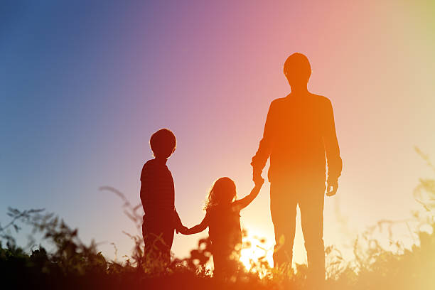istock father with son and daughter walk at sunset 598248282