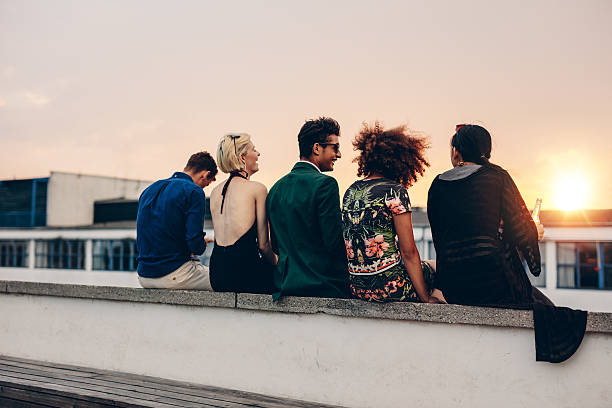 istock Young friends relaxing on terrace during sunset 598249176