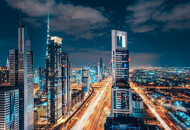 istock Nighttime Dubai skyline with illuminated skyscrapers and highway. 598251710