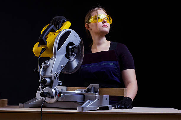 istock woman with a circular disk saw 598252058