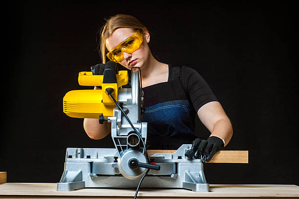 istock woman with a circular disk saw 598252104