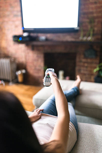 woman relaxing online on sofa reading some papers